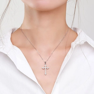 Sparkling 925 sterling silver cross necklace with pavé zircon stones on a model
