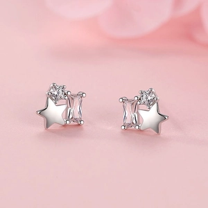 S925 silver star stud earrings with sparkling crystals on a soft pink background