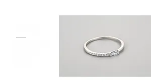 Close-up of square zirconia stone and claw setting on a minimalist silver ring