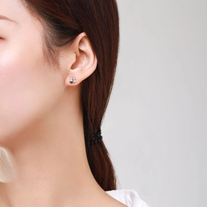 S925 sterling silver star stud earrings with cubic zirconia worn on a female ear