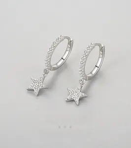 Detailed macro view of S925 silver star earrings with micro-set cubic zirconia stones