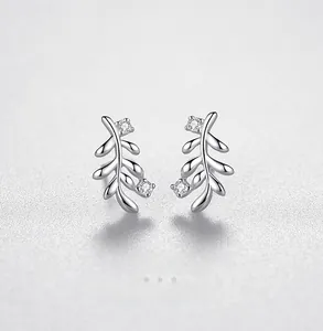 Macro detail of S925 sterling silver leaf earrings featuring sparkling zirconia stones