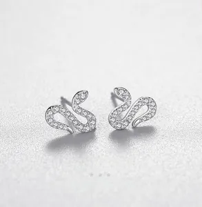 Detailed view of snake-shaped silver earrings with sparkling cubic zirconia pavé stones