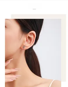Detailed view of leaf-shaped S925 silver stud earrings with crystals worn by a model
