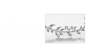 Macro detail of leaf-shaped silver necklace pendant featuring three inlaid round zircons