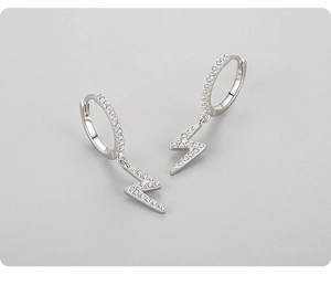 Macro shot of 925 sterling silver lightning bolt hoop earrings with cubic zirconia pave