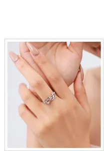 Detail view of s925 silver leaf ring with zircon stones on model finger