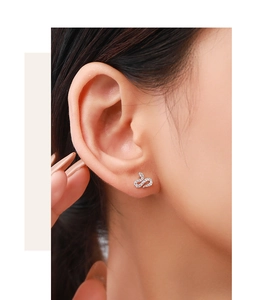 Close-up of S925 sterling silver snake earrings with pavé micro-inlaid diamonds on model