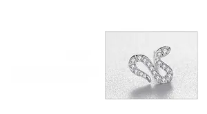 Macro detail of S-shaped silver snake stud earrings with pavé set sparkling crystals