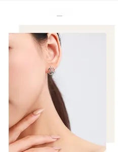Close-up of S925 sterling silver Tree of Life stud earrings worn by a model