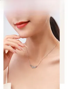 Close-up of S925 silver necklace with sparkling diamond flower cluster pendant on a model