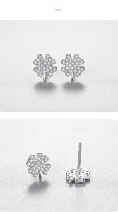 Detailed macro view of S925 sterling silver four-leaf clover earrings with pavé zircons