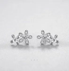 Macro view of S925 sterling silver daisy earrings with sparkling cubic zirconia stones