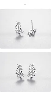 Macro view of S925 sterling silver leaf stud earrings with sparkling cubic zirconia stones