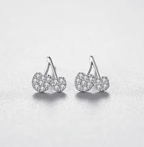 Macro view of S925 sterling silver cherry earrings with micro-paved cubic zirconia