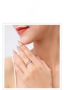 Detail of s925 silver hollow rhinestone ring on finger with elegant cutout design