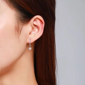 S925 sterling silver star drop earrings with micro-set zircon on model ear