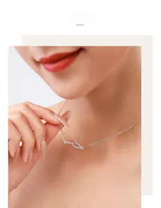 Close-up of S925 silver necklace with sparkling cubic zirconia crocodile pendant on model