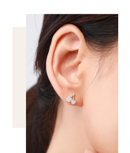 Close-up of S925 sterling silver cherry stud earrings with white cubic zirconia crystals