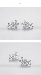 Close-up of S925 sterling silver daisy stud earrings with micro-inlaid zircon crystals