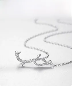 Detailed macro of silver Arabic calligraphy pendant with micro-pave zircon inlay