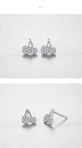 Detail view of silver cherry stud earrings with pave-set sparkling white cubic zirconia