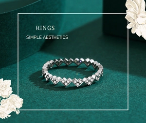 Detailed view of silver heart-shaped eternity ring with sparkling zircon insets