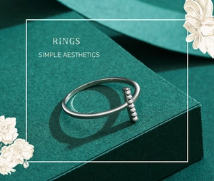 Close-up of minimalist S925 sterling silver ring with seven small zircons on a green stand