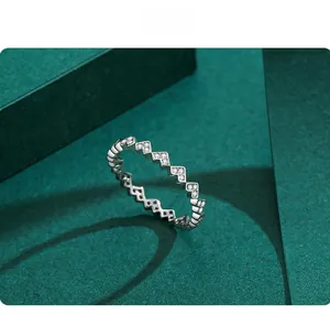 Macro view of a silver wavy sawtooth ring with sparkling white zircon stones