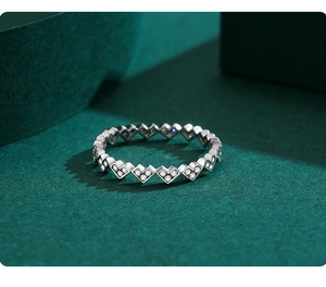 Macro shot of S925 sterling silver V-shaped heart ring with delicate sparkling zircons