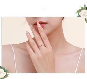 Close-up of minimalist S925 sterling silver twist ring with crystals on a model's hand