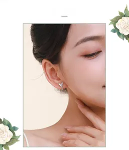 Close-up of model wearing small S925 sterling silver bow earrings with sparkling zirconia