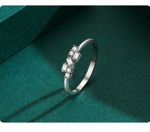 Detailed view of silver stackable ring with geometric rectangular and round diamonds