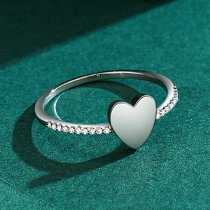 Elegant S925 silver heart ring with micro-set zircon accents on a textured green base