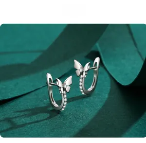 Macro detail of silver butterfly hoop earrings with sparkling cubic zirconia pavé