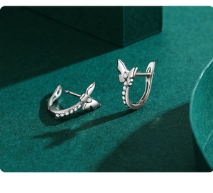 Close-up of S925 sterling silver bow earrings with sparkling pavé cubic zirconia accents