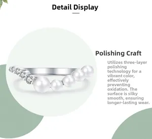 Detail view of V-shaped silver ring featuring white pearls and cubic zirconia stones
