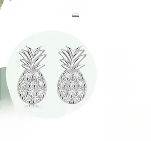 Macro view of S925 sterling silver pineapple studs with sparkling cubic zirconia inlay
