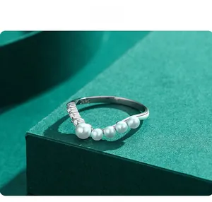 Detail of S925 silver V-shaped ring with gradient pearls and cubic zirconia stones