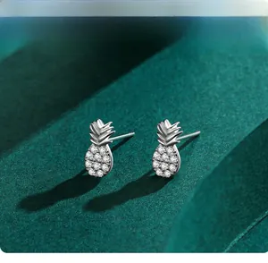 Macro shot of S925 silver pineapple stud earrings with micro-inlaid sparkling crystals