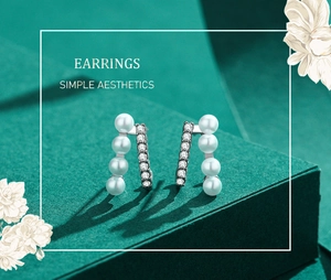 Detailed macro of S925 silver pearl and zircon earrings with minimalist double bar design
