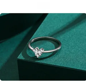 Close-up of S925 sterling silver heart ring with shimmering pavé diamonds on green box