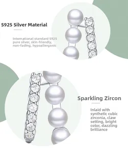 Detailed macro view of S925 sterling silver pearl stud earrings with zircon prong setting