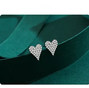 Macro shot of S925 sterling silver heart stud earrings with white zircon pavé setting
