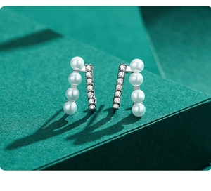 Close-up of S925 silver stud earrings featuring freshwater pearls and zircon stones