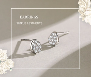 Macro shot of silver teardrop stud earrings featuring a full pavé crystal setting