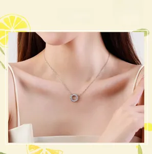 Close-up of S925 sterling silver daisy pendant necklace with zircon on a model