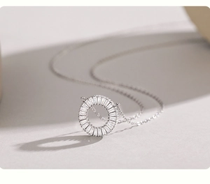 Macro detail of S925 silver necklace with sparkling rectangle-cut cubic zirconia pendant