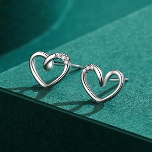 Minimalist S925 sterling silver heart-shaped stud earrings with zircon insets on dark green