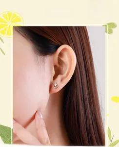 Close-up of minimalist s925 silver hoop stud earring with zircon on model's ear